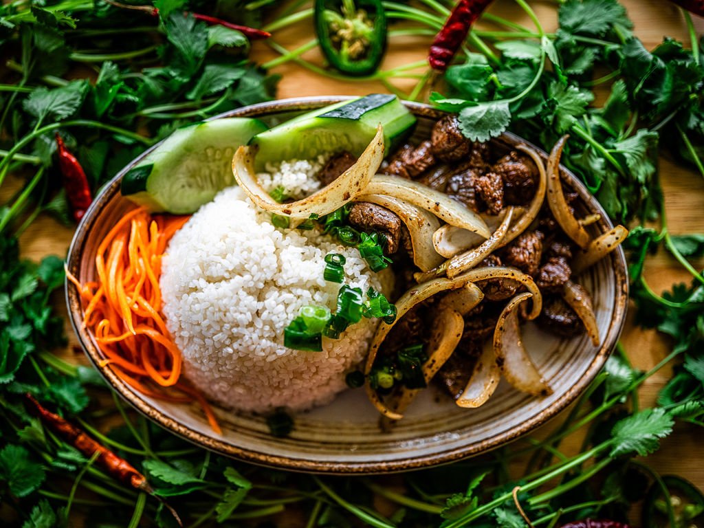 Sauteed beef cubes with onions, jasmine rice and greens